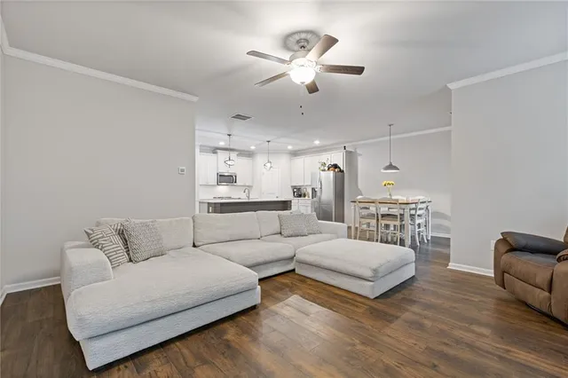 a view of a hallway with stairs and wooden floor