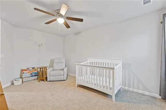 a kitchen with white cabinets stainless steel appliances and wooden floor