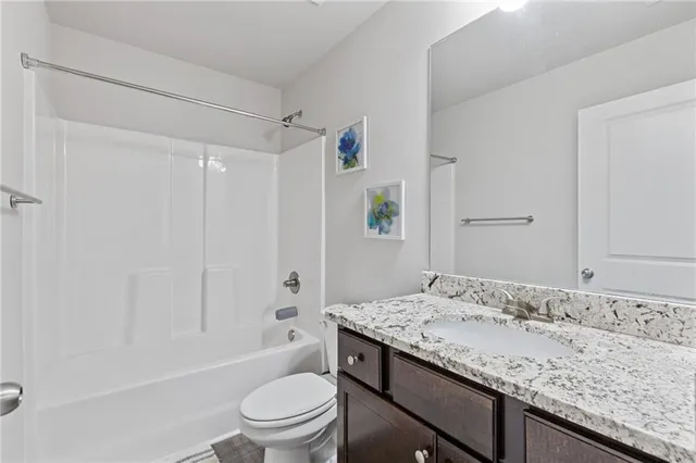 a kitchen with kitchen island granite countertop a sink cabinets and stainless steel appliances