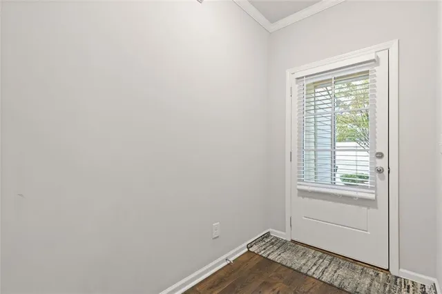 a living room with furniture and a view of kitchen