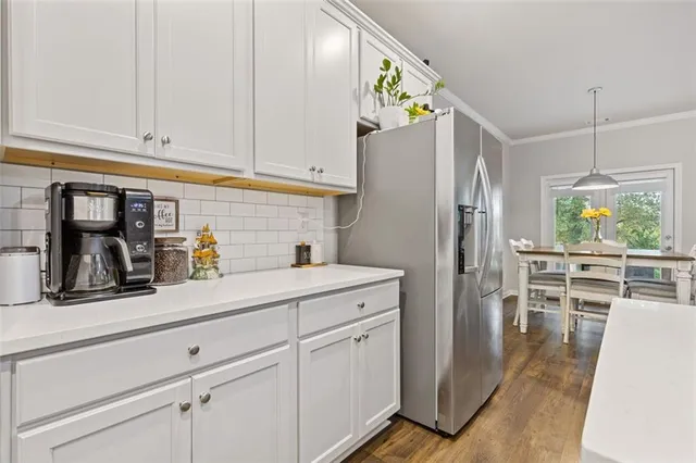 a view of a hallway with stairs and wooden floor