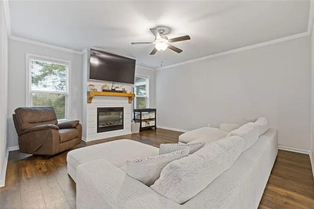 a bathroom with a granite countertop sink a toilet and shower