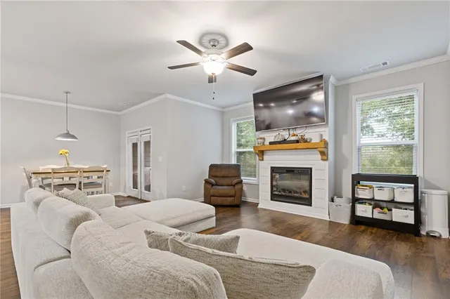 a living room with furniture a flat screen tv and a fireplace