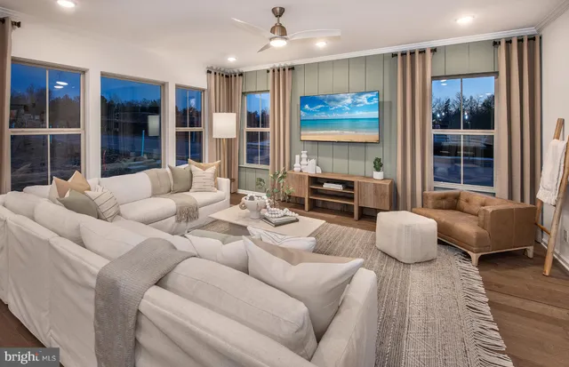 a living room with furniture and large window