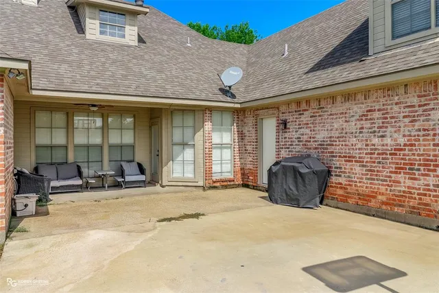 a view of a house with a yard and pathway