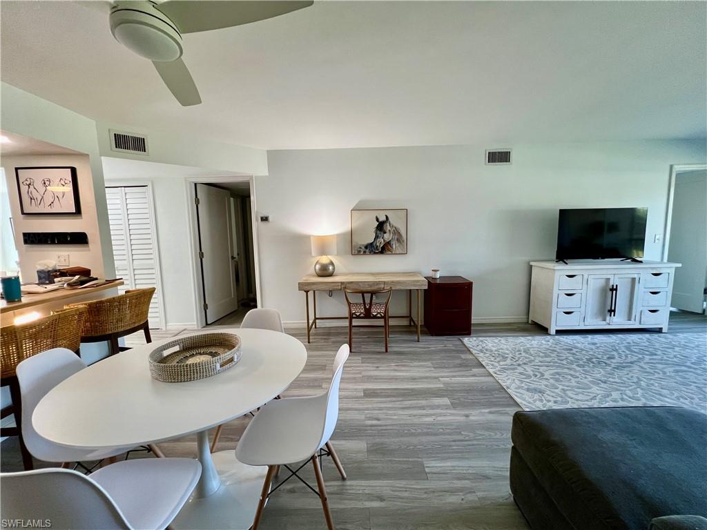 75 St Andrews Boulevard, Unit B203 Naples, FL 34113 - Photo 11 of 38 a living room with furniture and a flat screen tv