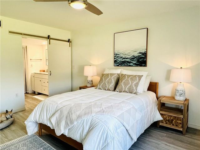 a bedroom with a bed and ceiling fan