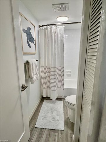 a bathroom with a granite countertop shower and a sink