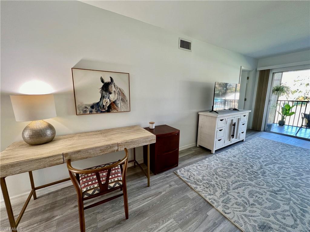 75 St Andrews Boulevard, Unit B203 Naples, FL 34113 - Photo 21 of 38 a living room with furniture and a baby crib