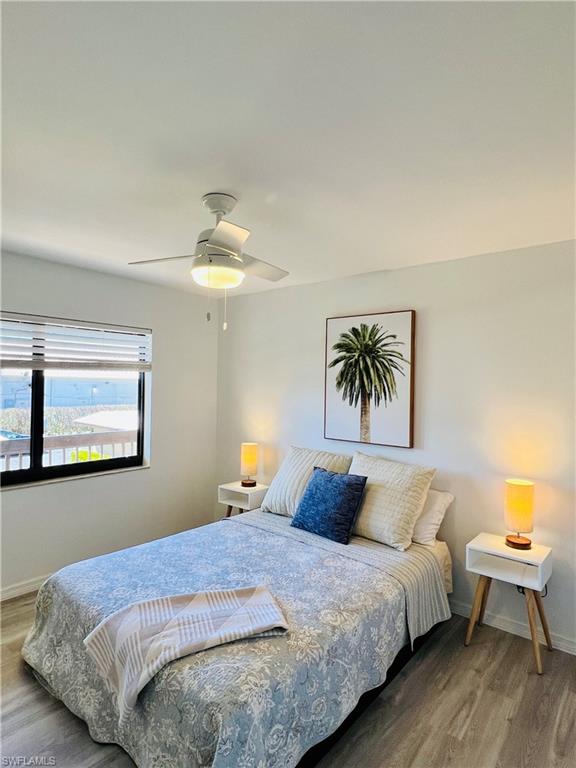 75 St Andrews Boulevard, Unit B203 Naples, FL 34113 - Photo 23 of 38 a bedroom with bed and window