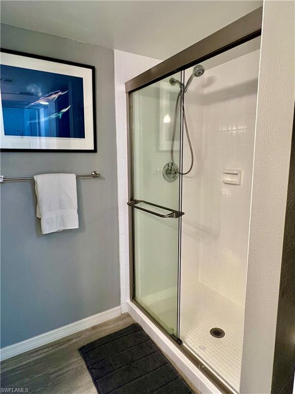 75 St Andrews Boulevard, Unit B203 Naples, FL 34113 - Photo 25 of 38 a bathroom with a glass shower door