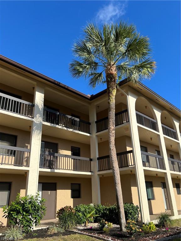75 St Andrews Boulevard, Unit B203 Naples, FL 34113 - Photo 28 of 38 a front view of a multi story building