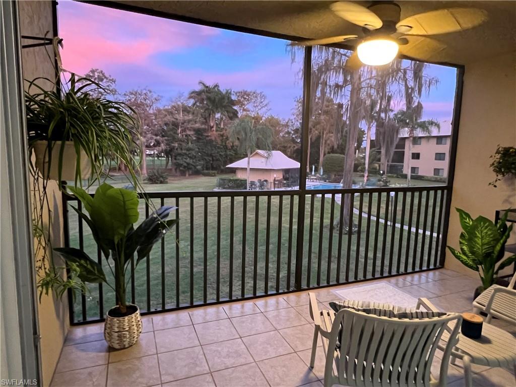 75 St Andrews Boulevard, Unit B203 Naples, FL 34113 - Photo 29 of 38 a view of a chairs with a flower in a patio
