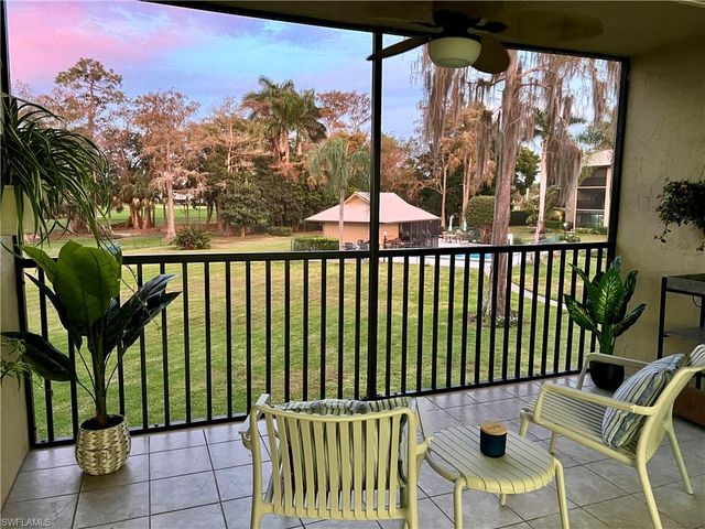 a view of a chairs and table in the balcony