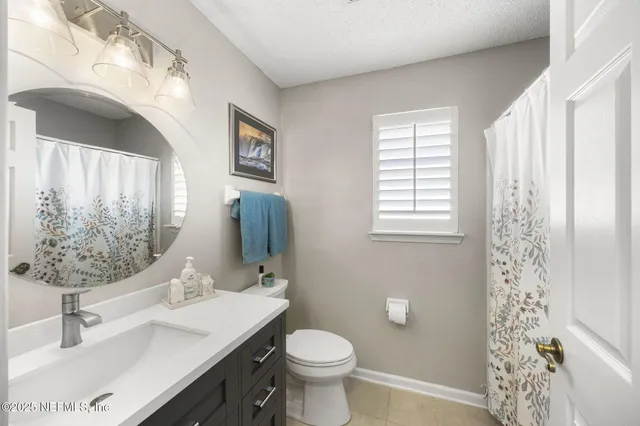 a bathroom with a sink toilet and a mirror