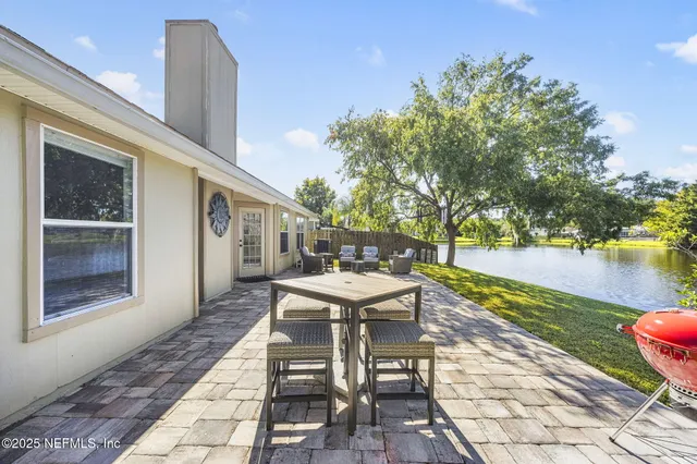 a view of a patio with couches table and chairs and potted plants