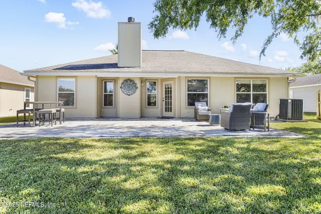 a view of a house with swimming pool and furniture