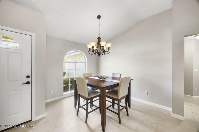 a dining room with furniture and window