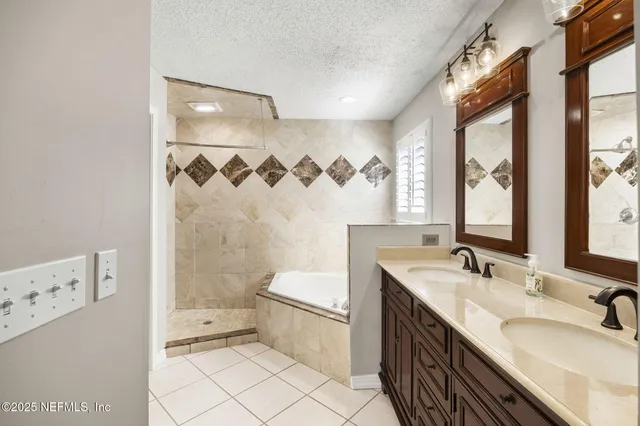 a bathroom with a double vanity sink toilet mirror and shower