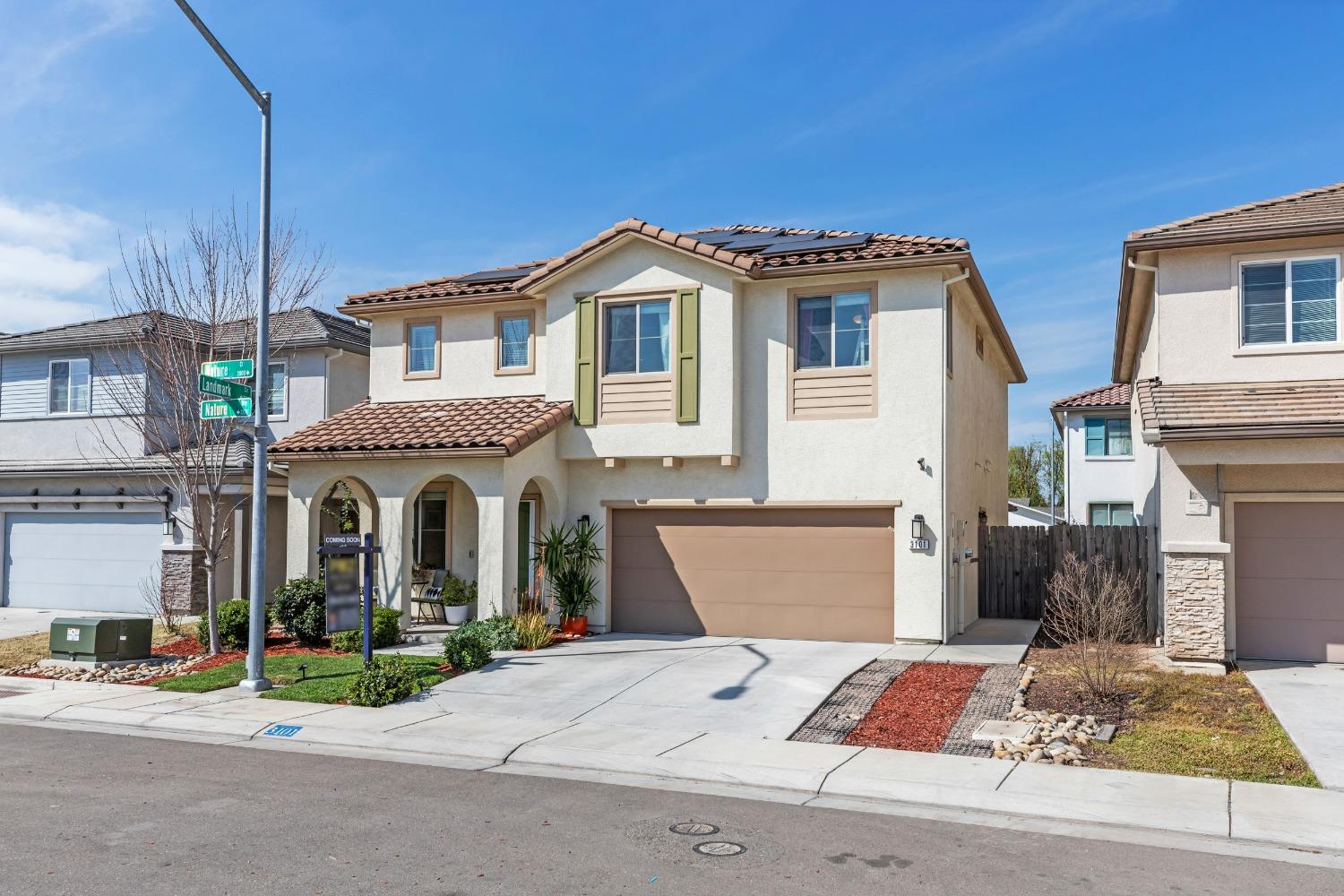 3101 Nature Way Modesto, CA 95356 - Photo 1 of 1 a front view of a house with a garden and plants