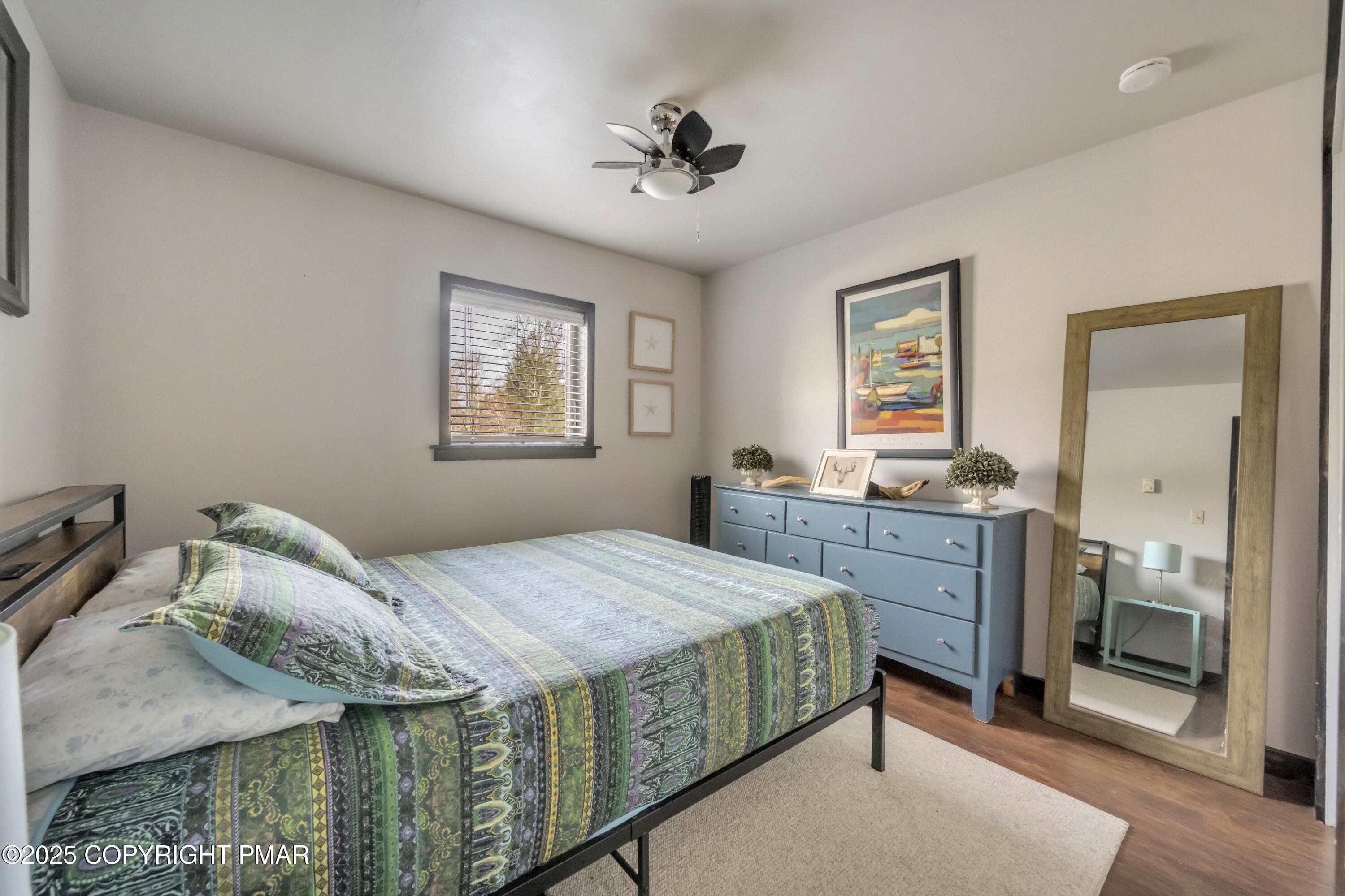 1126 Incline Village East Tannersville, PA 18372 - Photo 14 of 37 a bedroom with a bed and a chandelier