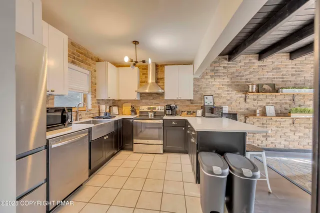 a kitchen with stainless steel appliances granite countertop a sink and cabinets