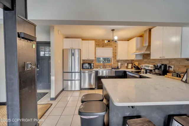 a kitchen with a refrigerator and a sink
