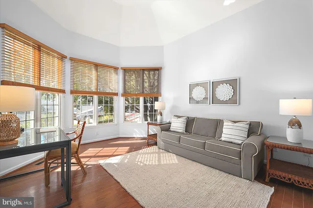 a living room with wooden floor and furniture