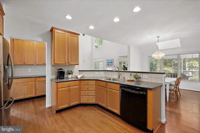 a kitchen with stainless steel appliances a sink a stove and cabinets
