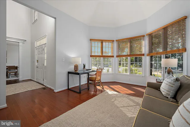a bedroom with a bed and painting on the wall
