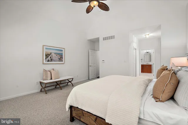 a spacious bedroom with a large bed and a window