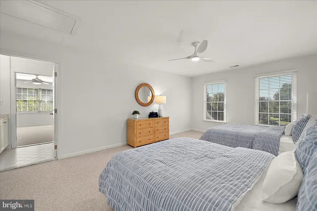 a view of a balcony with two chairs and a barbeque
