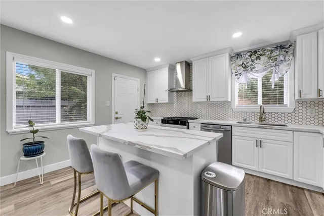a kitchen with appliances cabinets and furniture