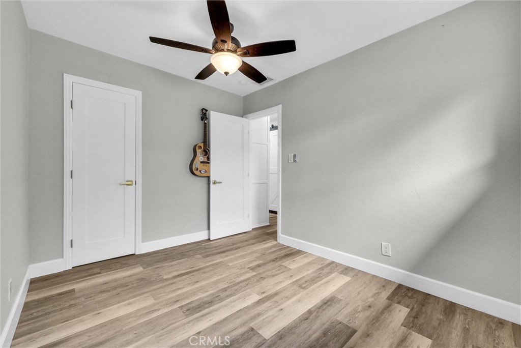 3625 Ross Street Riverside, CA 92503 - Photo 15 of 29 an empty room with wooden floor ceiling fan and windows