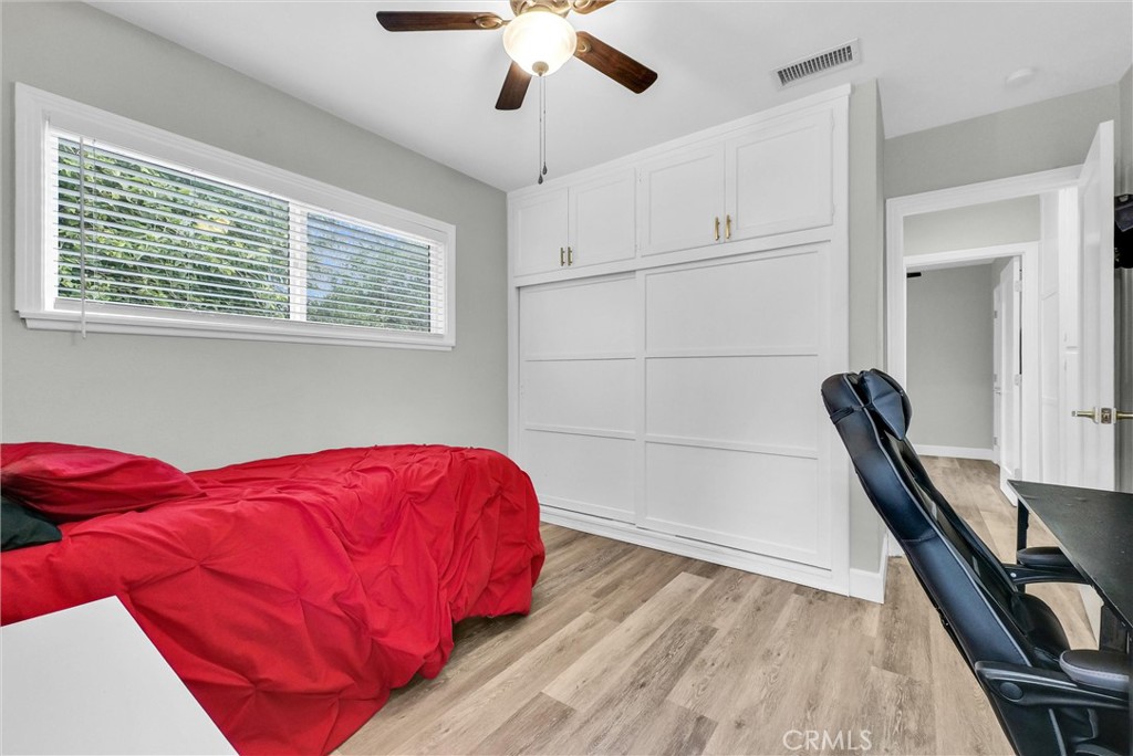 3625 Ross Street Riverside, CA 92503 - Photo 18 of 29 a view of a bedroom with a bed and wooden floor
