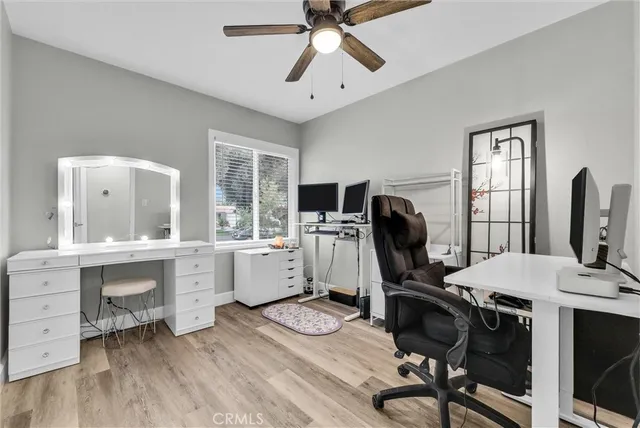 a view of a workspace with furniture and a window