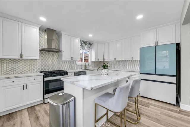 a kitchen with a stove a sink and a refrigerator