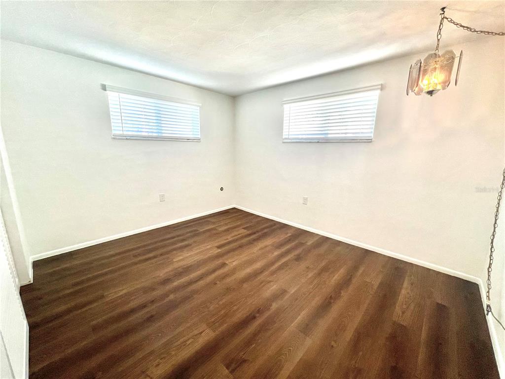 5137 Cicero Drive New Port Richey, FL 34652 - Photo 11 of 16 a view of a room with wooden floor and a window