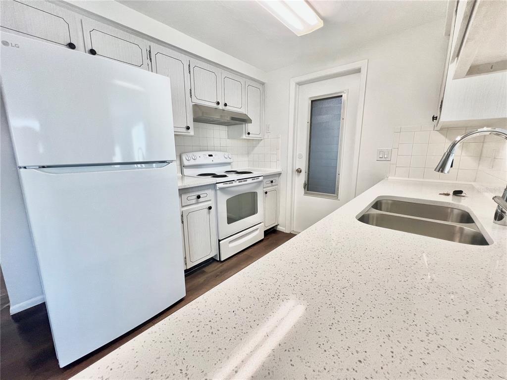 5137 Cicero Drive New Port Richey, FL 34652 - Photo 7 of 16 a white refrigerator freezer sitting in a kitchen