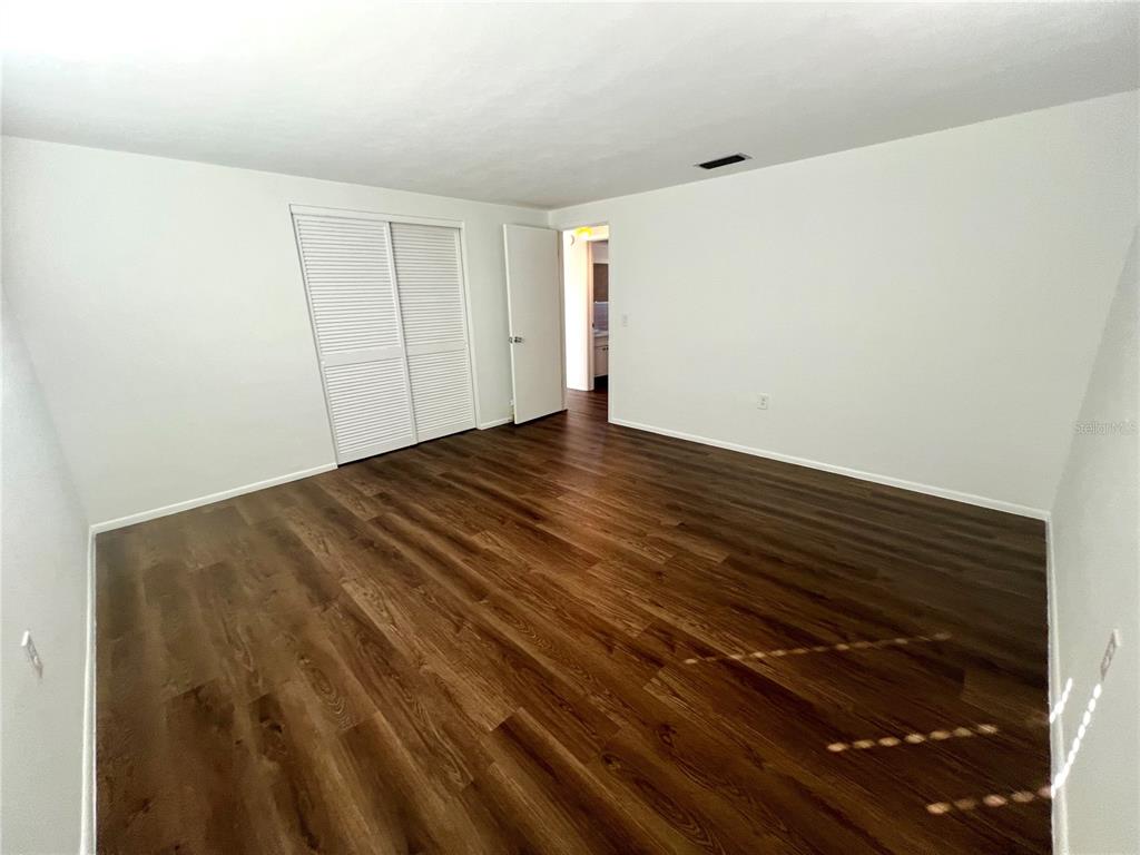 5137 Cicero Drive New Port Richey, FL 34652 - Photo 9 of 16 a view of empty room with wooden floor