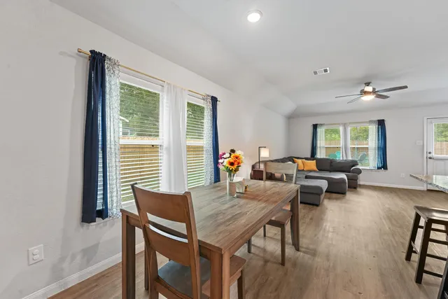 a view of a dining room with furniture window and wooden floor