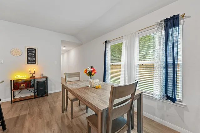 a view of a dining room with furniture window and wooden floor