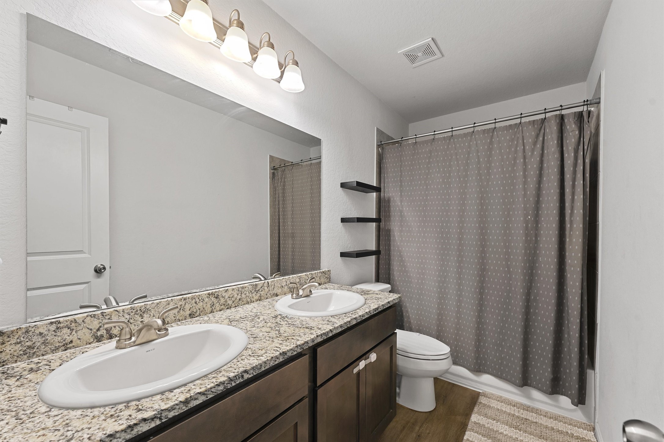 15177 Coaltown Road Willis, TX 77378 - Photo 15 of 25 a bathroom with a granite countertop sink a toilet and a mirror