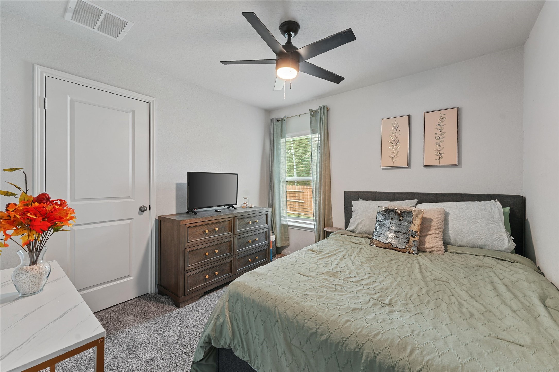 15177 Coaltown Road Willis, TX 77378 - Photo 19 of 25 a bedroom with a bed and a dresser