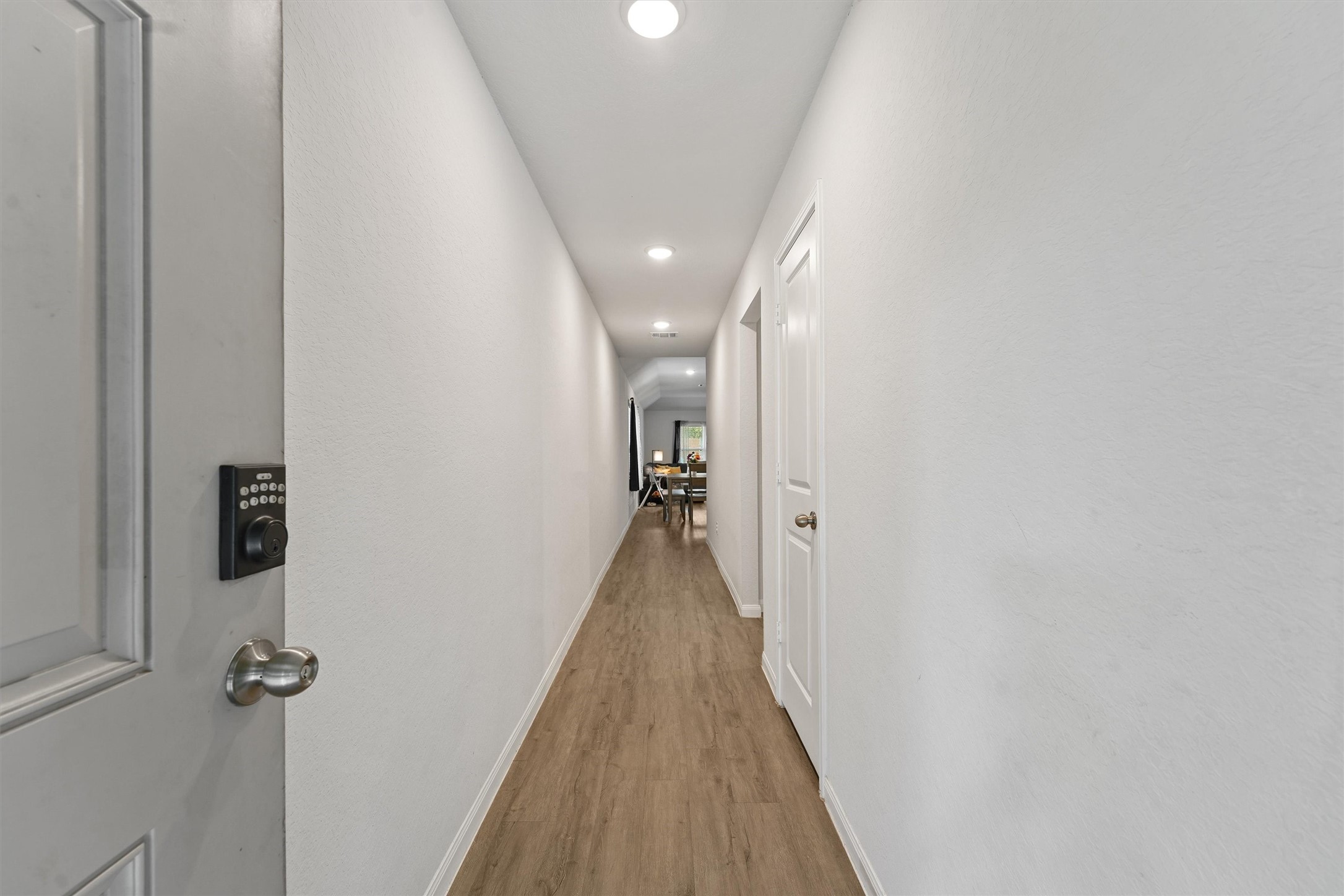 15177 Coaltown Road Willis, TX 77378 - Photo 3 of 25 a view of a hallway with wooden floor and staircase