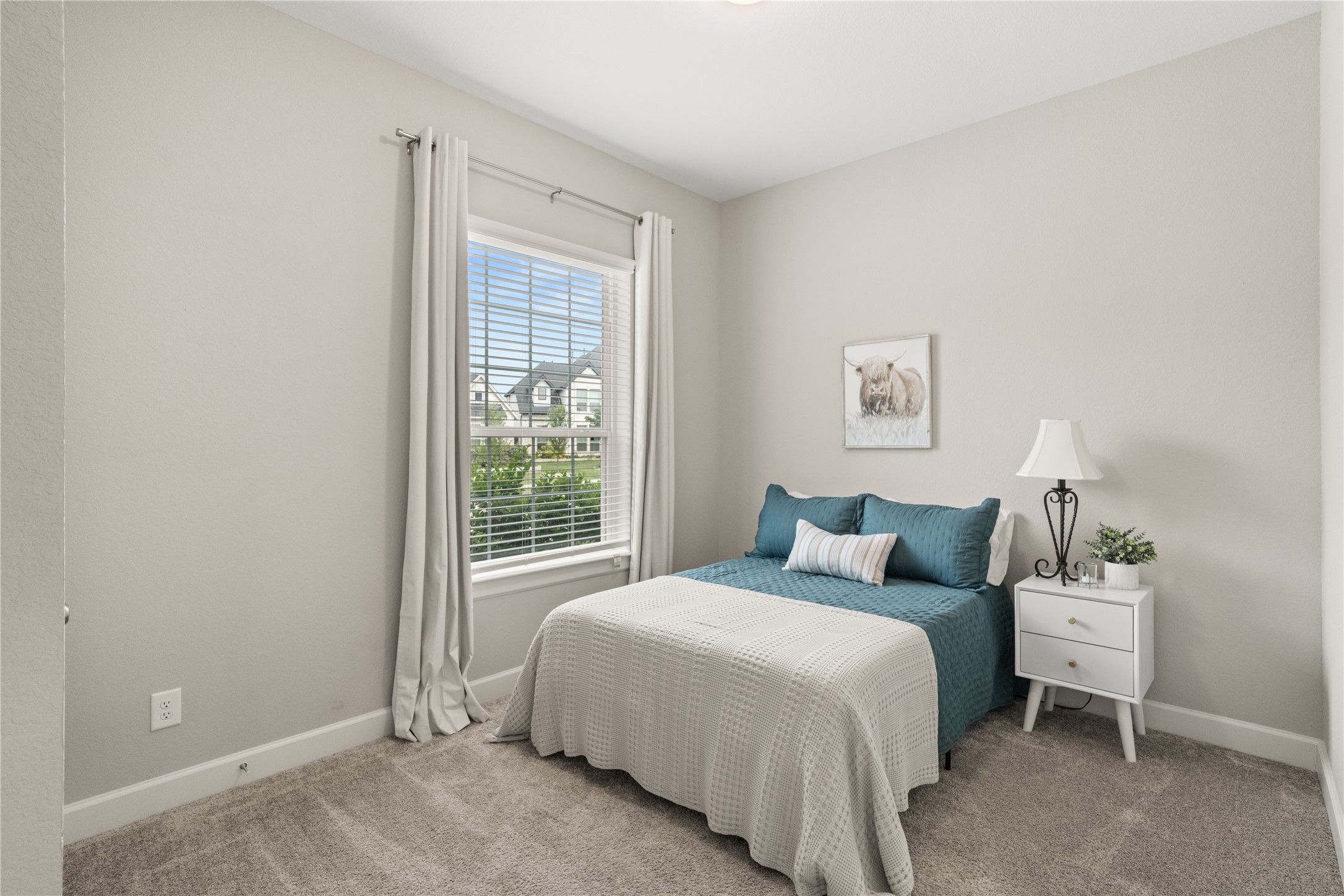 3118 Swift Way Katy, TX 77493 - Photo 25 of 34 Bedroom – This bright secondary bedroom features soft neutral tones, plush carpeting, and a large window that fills the space with natural light. A clean, versatile layout makes it ideal for guests or everyday living.