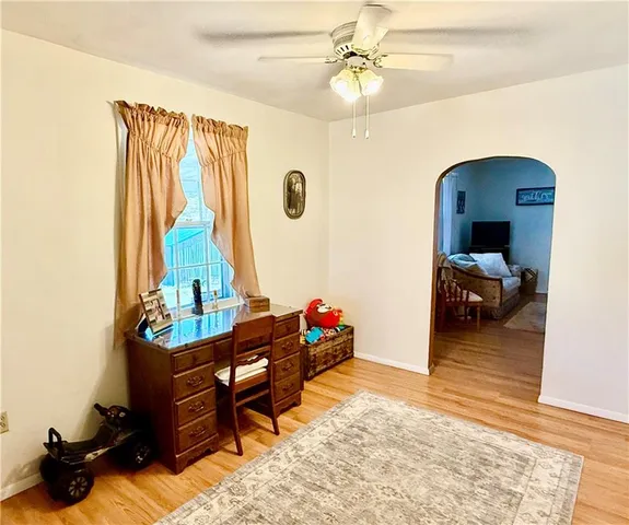 a living room with furniture and a dresser
