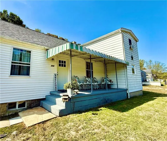 a view of a house with backyard porch and sitting area