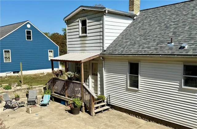 a view of a house with a patio and a barbeque