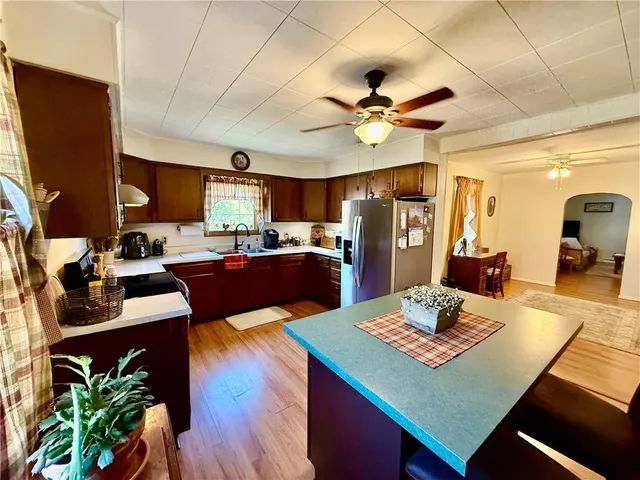 a kitchen with a table chairs refrigerator and microwave